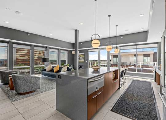 A modern kitchen with a large island and a view of the outdoors.