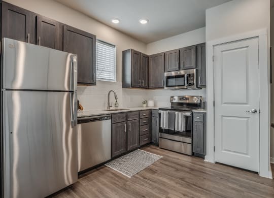 Kitchen with Dark Brown Cabinetry and Stainless Steel Appliances
