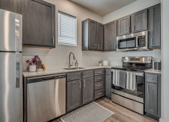 Kitchen with Dark Brown Cabinetry and Stainless Steel Appliances
