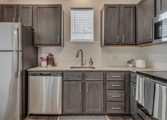Kitchen with Dark Brown Cabinetry and Stainless Steel Appliances