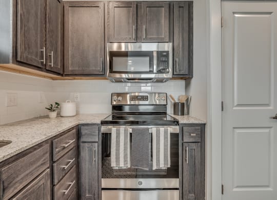 Kitchen with Dark Brown Cabinetry and Stainless Steel Appliances