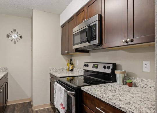 Renovated Kitchen With Espresso Cabinets, Granite Counters & Stainless Steel Appliances