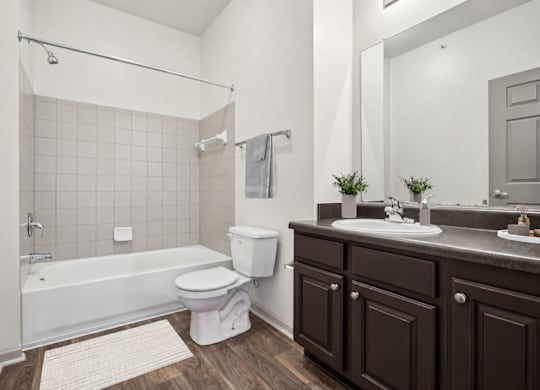 A white bathroom with a white tub and toilet.