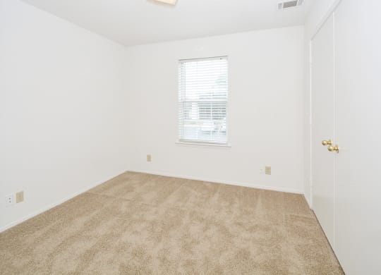 Carpeted Bedroom with Window and Built-In Blinds