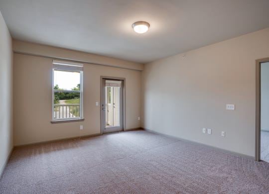 Spacious Room with Plush Carpet and Glass Patio Door
