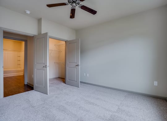 Bedroom with Ceiling Fan and Double Door Closet