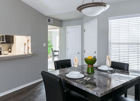 Kitchen Access Through Dining Room with Wood Style Flooring