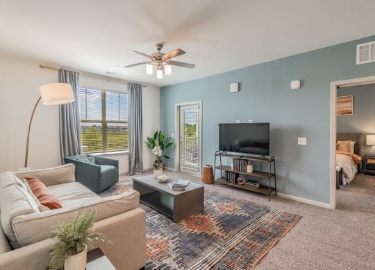 Spacious Living Room With Glass Patio Door Leading Out To Balcony