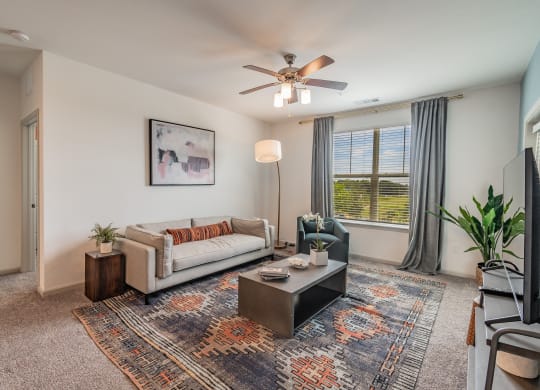 Carpeted Living Room With Tall Ceilings & Large Windows
