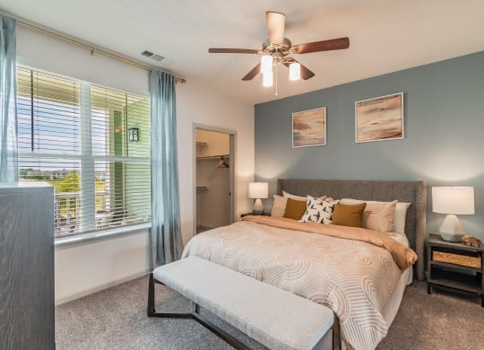 Bedroom With Large Windows & Built-In Window Treatments