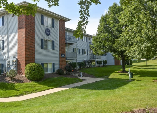 Lush Greenery and Grass in Front of a Grand Ridge Apartment Building