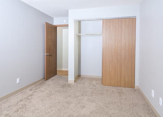a bedroom with a closet and an open door
