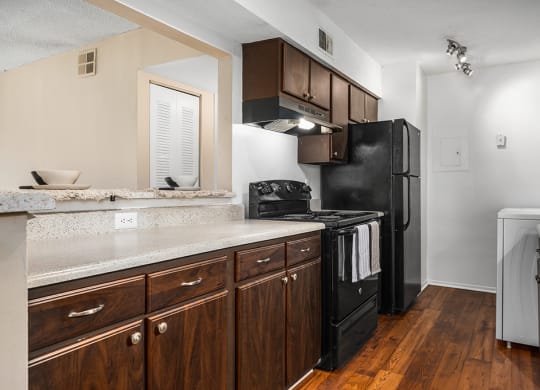 Kitchen With Wood-Style Flooring & Overhead Track Lights