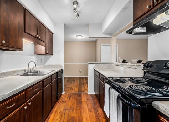 Galley Kitchen With Black Appliances & Espresso Cabinets