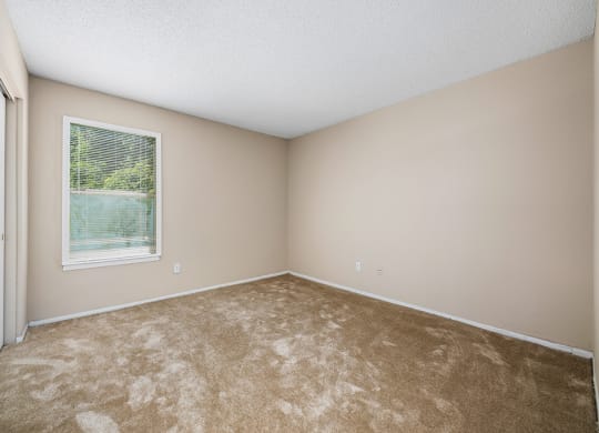 Bedroom With Large Window & Built-In Window Treatments