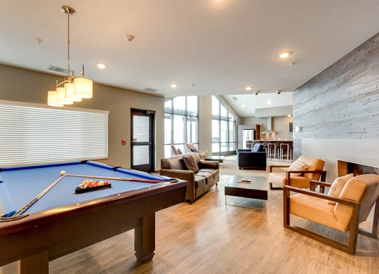 a game room with a pool table and a living room