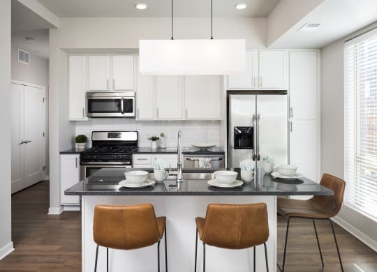 Beautiful Kitchen With Light Cabinetry & Stainless Steel Appliances