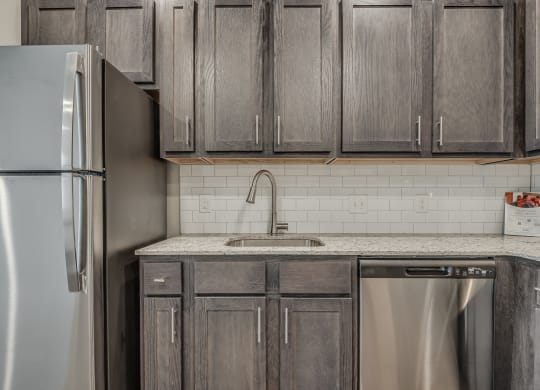 Kitchen with Dark Brown Cabinetry and Stainless Steel Appliances