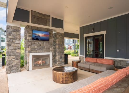 Outdoor Lounge with Mounted TV and Fireplace