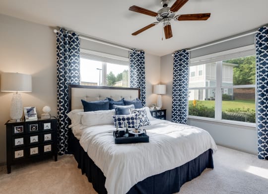 Bedroom With Multiple Windows That Let In Lots Of Natural Light