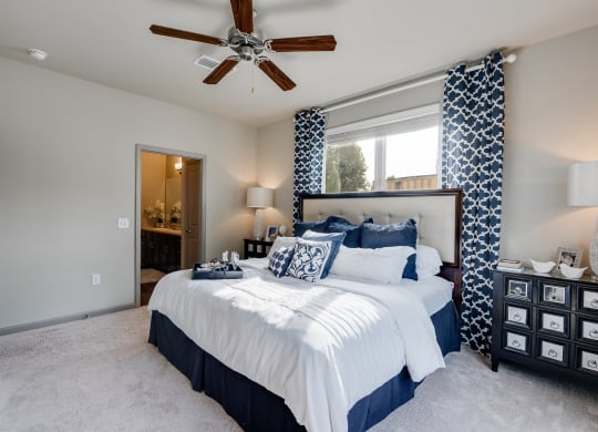 Bedroom With Tall Ceilings & Large Windows