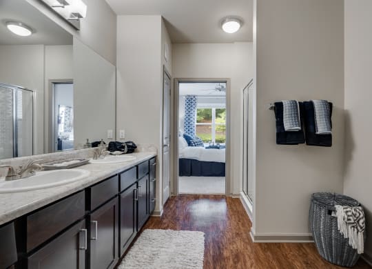 Spacious Bathroom With Wood-Style Flooring & Dual Bathroom Vanity