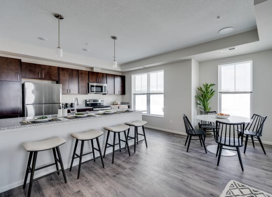 Expansive Granite Kitchen Island With Four Bar Stool Seats