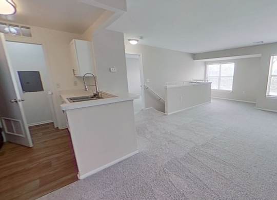 Open-concept living with spacious living area, large windows, and kitchen