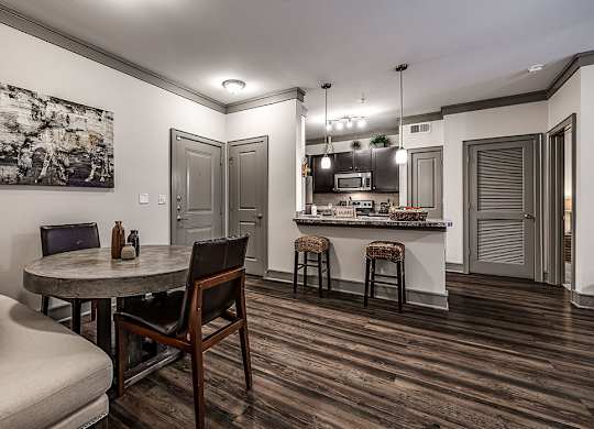 A modern kitchen with a dining table and chairs.