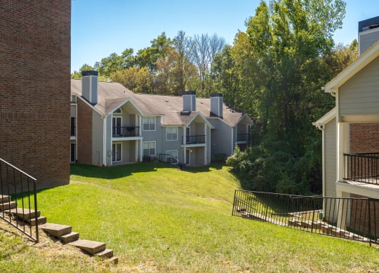 Large Grass Area with Sloping Hill Between Pelican Cove Apartment Buildings