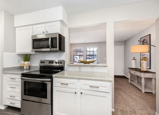 Renovated Kitchen with White Tile Backsplash and Stainless Steel Appliances