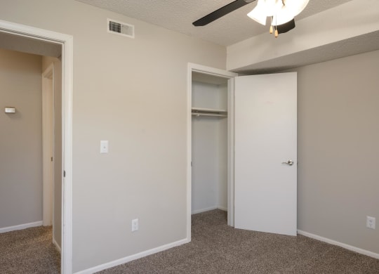 Bedroom With Plush Carpeting & Ceiling Fan With Light