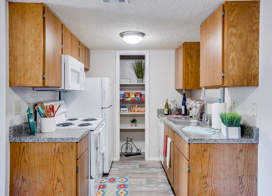 Kitchen with White Appliances and Pantry Closet