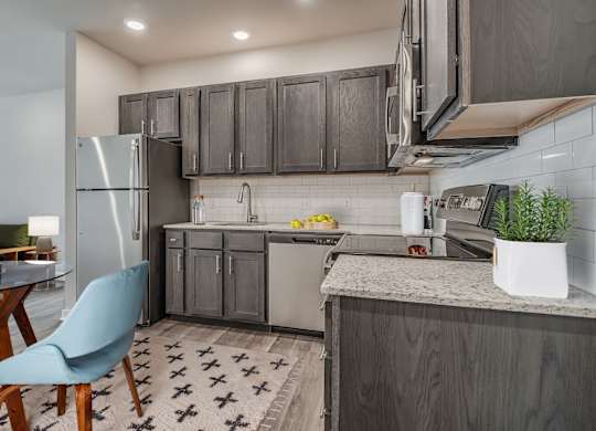 Kitchen with Dark Brown Cabinetry and Stainless Steel Appliances