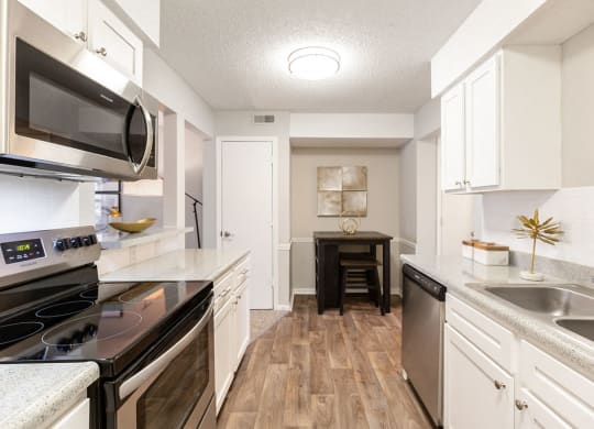 Renovated Kitchen with Stainless Steel Appliances, White Cabinets and Wood Style Flooring