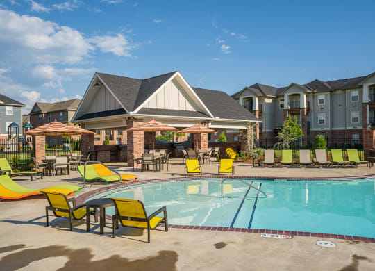 Expansive Pool Area with Lounge Chairs and Sun Umbrellas