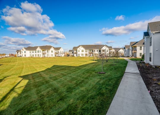 Lush Grass Area Behind Apartment Homes At Sundance Woodbury