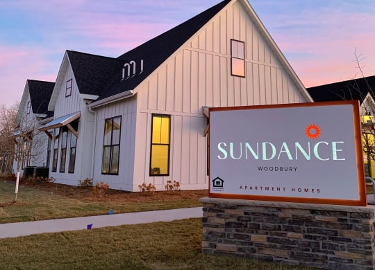 Exterior of the Clubhouse with Monument Sign at Dusk
