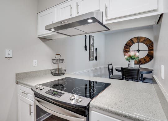 Stainless Steel Stove Overlooking the Dining Room Area