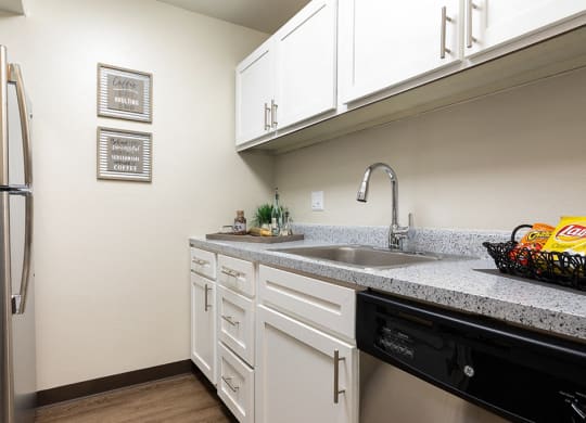 Kitchen with White Cabinets, Stainless Steel appliances and Hardware