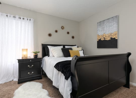 Bedroom with Plush Carpet and Large Window with Built-In Blinds