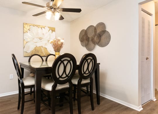 Spacious Dining Room with Ceiling Fan and Light and Hardwood Style Flooring