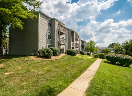 Exterior Of Apartment Homes With Lush Green Grass