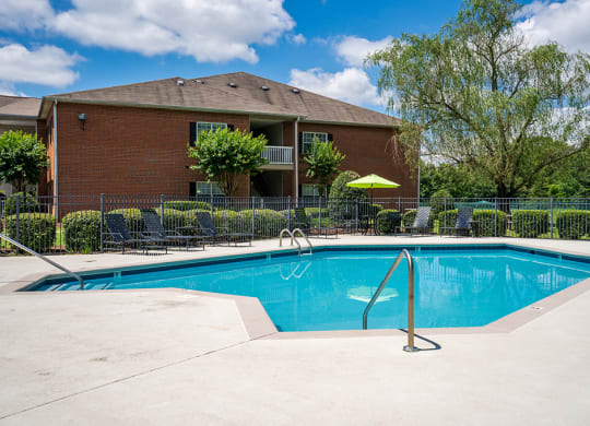 Fenced In Pool Area with Expansive Sundeck and Lounge Chairs