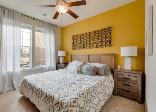 Bedroom With Plush Carpet & Large Windows