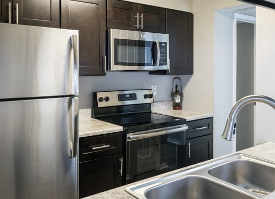 Fully-Equipped Modern Kitchen with Stainless Steel Appliances with Granite Countertops