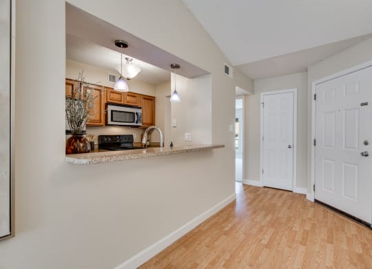 Kitchen With Peek Through Window With Countertop Breakfast Bar