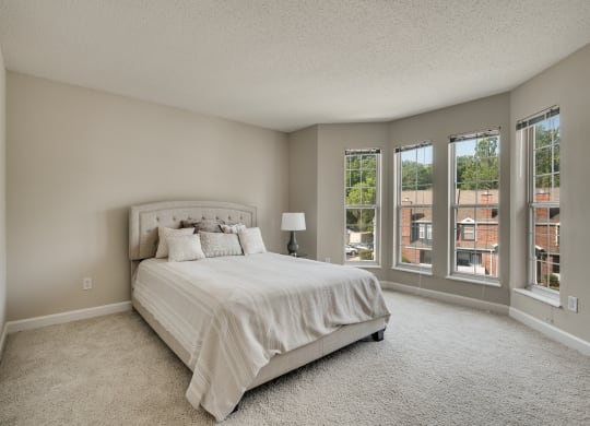 Spacious Carpeted Bedroom With Bay Windows