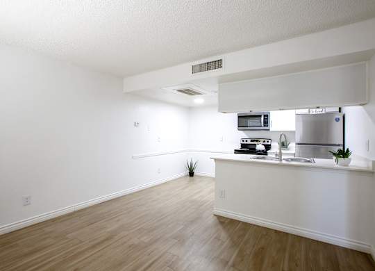 A kitchen area with a counter and a microwave.