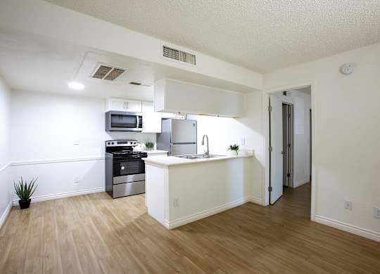 A kitchen with a stove top oven and a microwave.